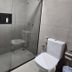 Village Iguassu Hotel bathroom with glass-enclosed shower and toilet in Foz do Iguaçu