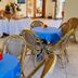 Residence Esmeraldo in Capo Vaticano: hotel dining area with round tables and woven chairs