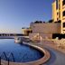 Park Hotel Mirabeau in Gasperina with a curved outdoor pool and sea view at sunset