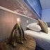 Sea You Hotel Noordwijk room with bedside octopus lamp beside a bed and beach wall mural in Noordwijk