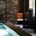 Åsby Hotell in Hallstahammar with an indoor pool beside brick walls and a glass door