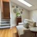 Mccall House Boutique Inn in Ashland sitting area with tufted sofa, skylight, and wood floors