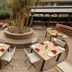 Hotel Himalaya Kathmandu courtyard dining terrace with round tables and central bamboo planter in Kathmandu