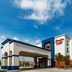 Hampton Inn & Suites by Hilton Tomball Houston NW exterior with covered entrance and blue accents in Tomball