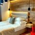 Karczma Rzym in Bydgoszcz, cozy hotel room with double bed, pendant lights, and wood-paneled wall