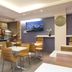 Lille City Hotel in Lille breakfast room with tables, chairs, buffet counter and wall-mounted TV