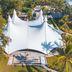 Golden Tulip Dar Es Salaam aerial view of a large white tented event pavilion and palm trees