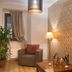 Hotel City Pisek in Písek guest room with armchair, lamp, potted plant and patterned wall