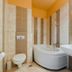 Esmeralda Hotel, Kremastí bathroom with corner bathtub, wall-mounted toilet and sink