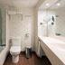 Bathroom at Tahití Playa Suites in Santa Susanna with tub-shower, toilet and vanity sink