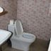 Azzurro Di Boracay Resort bathroom with sink, toilet, and pink tiled walls in Boracay