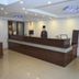Hotel Apple Valley front desk reception area in Kodaikanal with a long wooden counter and chandelier lighting