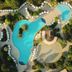 Hyatt Regency Thessaloniki aerial view of lagoon-style pools, sun loungers, and landscaped gardens
