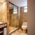 Hotel Porton De La Cabrera Bogotá bathroom with glass shower, vanity sink and wall-mounted toilet