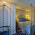 Mendocino Hotel and Garden Suites bedroom with four-poster bed and floral wallpaper in Mendocino