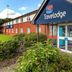 Travelodge Manchester Birch M62 Eastbound in Heywood, exterior entrance with landscaped shrubs