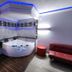 Motel 6 Little Rock North jacuzzi suite with red sofa and blue LED ceiling in North Little Rock