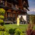 Silverton in Białka Tatrzańska with chalet-style balconies, garden lawn, and a canopy seating area