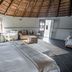 Bella Manga Country Escape in Plettenberg Bay: rustic suite with thatched ceiling, king bed, seating area and large windows