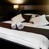 Euro Hotels Drzonków guest room with double bed, bedside lamp, chair and flower vase