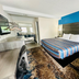 Red Carpet Inn Orchard Park guest room with king bed, desk, and blue accent wall