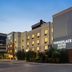 TownePlace Suites by Marriott Williamsport exterior at dusk with lit windows and street corner view