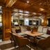 Hotel Zurserhof in Zürs lounge with carved wood ceiling, plush seating, and flower arrangements