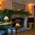The White Horse in Dorking: cozy lounge with lit fireplace, wood floors, and armchairs
