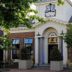 Hotel Abdij Dokkum in Dokkum exterior with arched entrance, brick facade, and trees