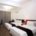 Hanoi Crystal Hotel in Hanoi: twin beds, desk, wall-mounted TV and curtains in a simple guest room