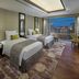 Mandarin Oriental, Kuala Lumpur guest room with twin beds and city skyline view