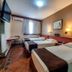 Stream Hotéis in Ribeirão Preto guest room with three single beds, wall-mounted TV, and window