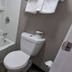 Motel 6 Leominster MA bathroom with tub, toilet, towels and toilet paper holder