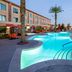Cannery Casino Hotel in North Las Vegas pool area with palm trees and loungers