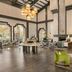 Hilton Scottsdale Resort & Villas lobby with high ceilings, hanging lights, fireplace seating and green chairs in Scottsdale