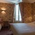 Neuilly Park Hotel in Neuilly-sur-Seine guest room with bed, window, and sitting area