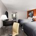 Super 8 by Wyndham Bulls Gap Greeneville Area room with two beds and orange accent wall