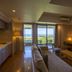 Moon Ocean Ginowan Hotel & Residence room with sofa, kitchenette, and balcony sea view in Ginowan