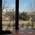 Hotel Pago del Olivo in Simancas with large windows overlooking a hillside town and road