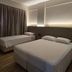 Village Iguassu Hotel room in Foz do Iguaçu with two beds and soft wall lighting