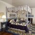 Osceola Mill House B&B in Gordonville guest room with four-poster bed, plaid chair and patterned rug