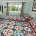 Governor's Rock Motel in Shaftsbury room with two quilted beds and a window view of trees