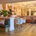 The White Horse in Dorking dining room with booth seating, patterned tables, and warm pendant lighting.