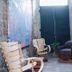 Hotel Boutique Casareyna in Puebla City: cozy courtyard seating with chairs, plant, and stone walls