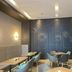 Orange Hotel Beijing Tianning Temple lobby seating area with tables, chairs and decorative wall art in Beijing