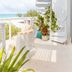 Palm Heights North Side balcony with spiral staircase, ocean view, and potted plants