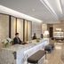 Fraser Suites Singapore lobby with marble front desk, seating, and chandelier lighting