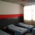Hotel Prata in Vitória guest room with four single beds and bright window light