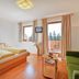 Gasthof Bärnstatt room in Scheffau am Wilden Kaiser with balcony, mountain view and sofa
