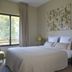 Hôtel Les Herbes Folles room in Mauregard with a double bed, window, curtains and bedside lamps